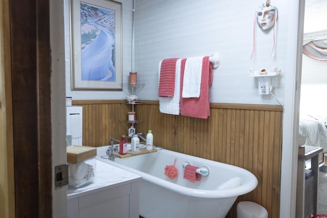 27126 Road R, Dolores, CO 81323 - full bath with a freestanding tub, a wainscoted wall, and wood walls