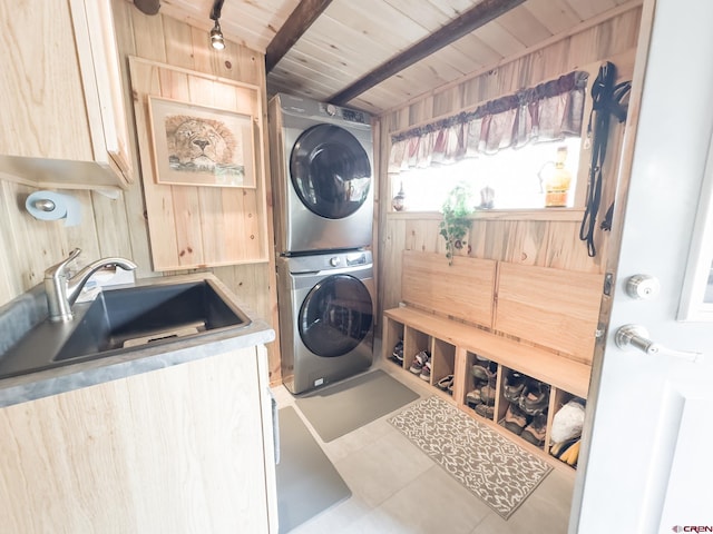 27126 Road R, Dolores, CO 81323 - laundry room featuring stacked washer and clothes dryer, tile patterned flooring, wood walls, and wooden ceiling