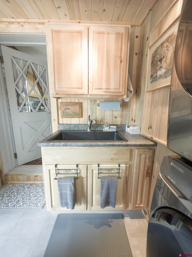 27126 Road R, Dolores, CO 81323 - kitchen with light brown cabinetry, estacked washer and dryer, and light tile patterned flooring
