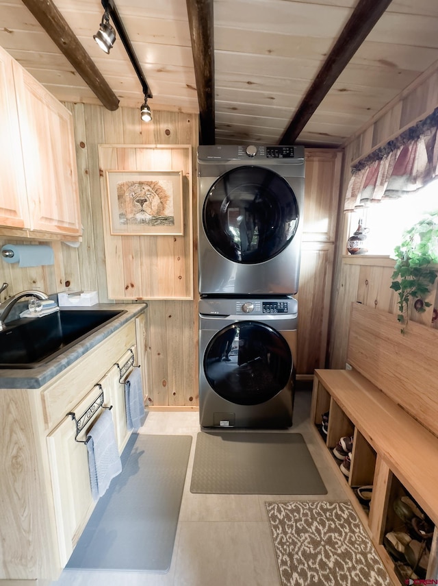 27126 Road R, Dolores, CO 81323 - laundry area with estacked washer and dryer, wood walls, wooden ceiling, and light tile patterned floors