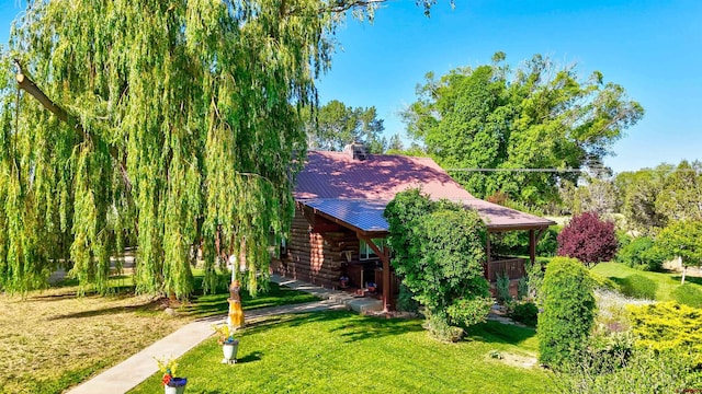 27126 Road R, Dolores, CO 81323 - view of front of home with log siding, a front lawn, and a metal roof