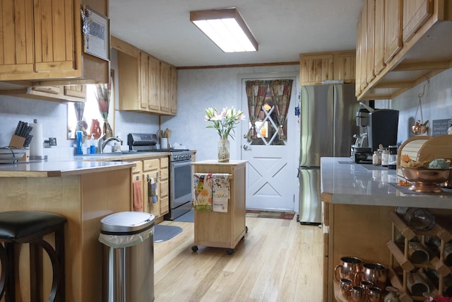 27126 Road R, Dolores, CO 81323 - kitchen featuring stainless steel appliances, light wood-type flooring, light countertops, and a center island