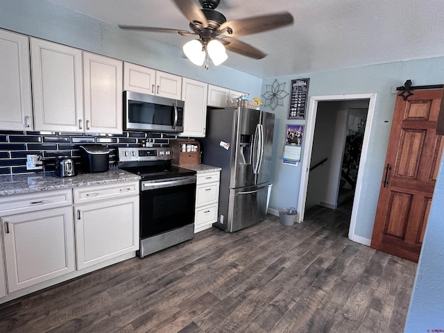9456 6075th Rd, Montrose, CO 81403 - kitchen with appliances with stainless steel finishes, white cabinetry, a ceiling fan, tasteful backsplash, and dark wood finished floors