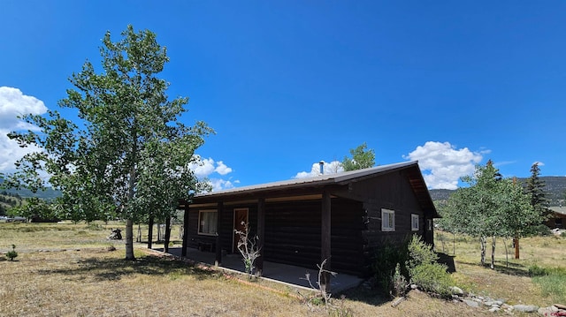 59 Willow St, South Fork, CO 81154 - view of home's exterior with a metal roof and log siding