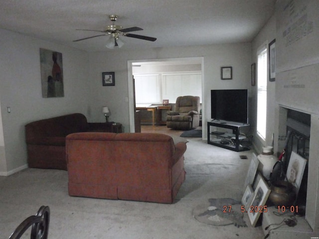 47 Segovia Dr, Hot Springs, AR 71909 - living room featuring carpet, a glass covered fireplace, and a ceiling fan