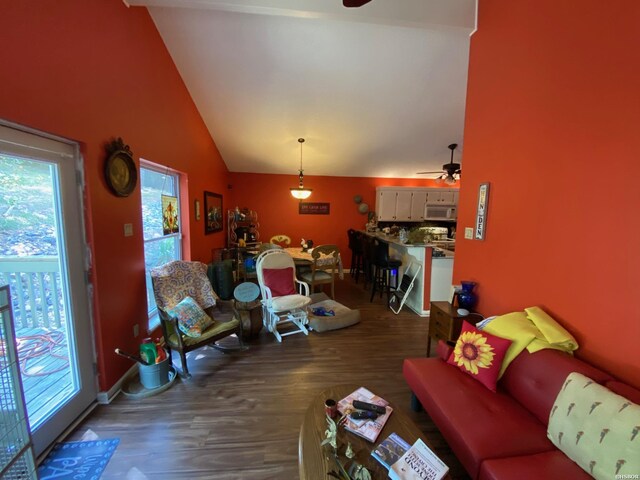 living room featuring high vaulted ceiling, dark wood-style flooring, and ceiling fan