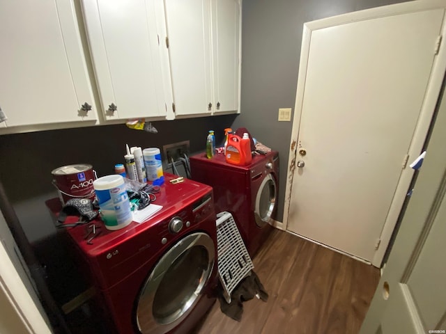 laundry area with dark wood finished floors, cabinet space, and independent washer and dryer