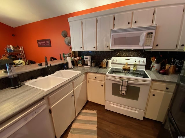 kitchen with white appliances, white cabinets, decorative backsplash, light countertops, and a sink