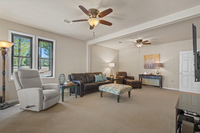 living room featuring carpet floors, baseboards, visible vents, and a ceiling fan