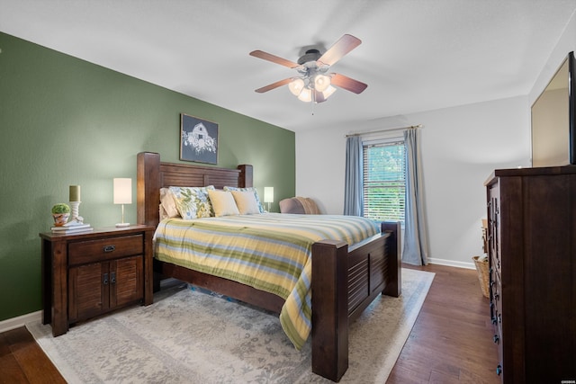 bedroom with light wood-type flooring, a ceiling fan, and baseboards