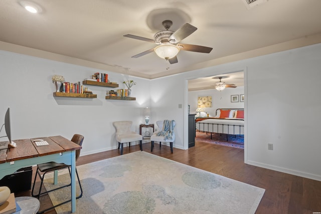 office area with dark wood-style flooring, visible vents, and baseboards