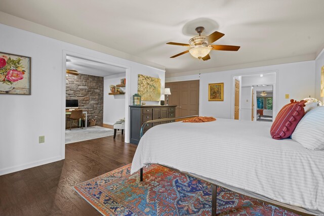 bedroom featuring baseboards, dark wood finished floors, and a ceiling fan