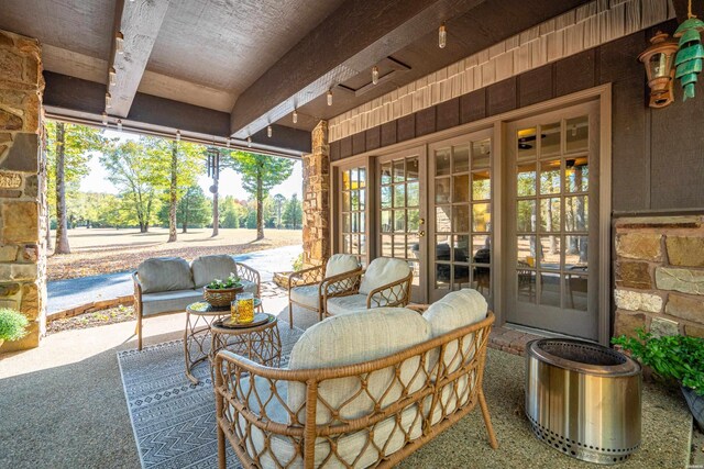 sunroom / solarium featuring beamed ceiling