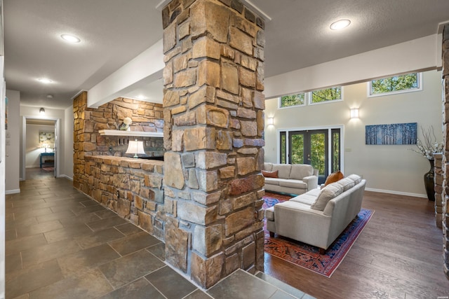 living room with recessed lighting, dark wood finished floors, a textured ceiling, and baseboards