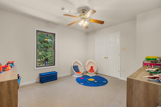 rec room featuring baseboards, carpet floors, visible vents, and a ceiling fan