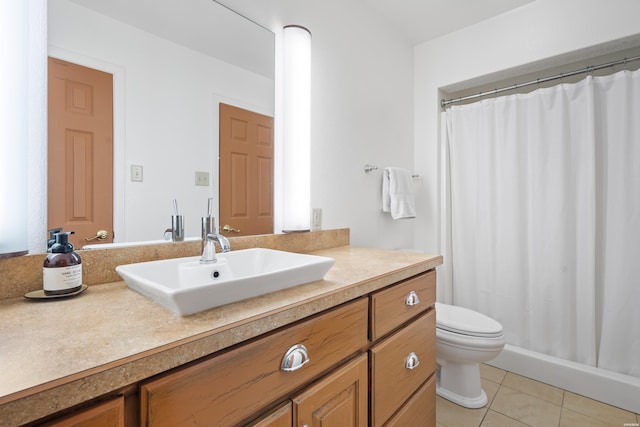 bathroom with tile patterned flooring, vanity, and toilet