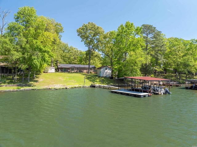 dock area with a yard and a water view