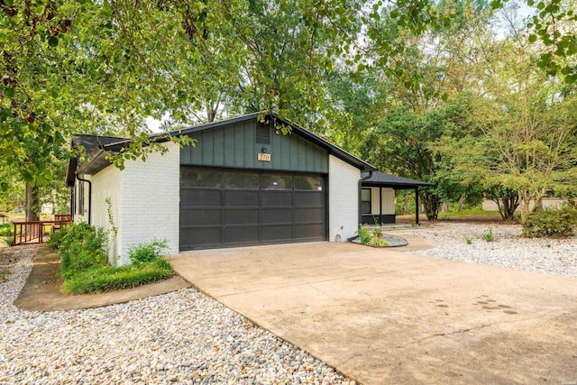 garage featuring concrete driveway