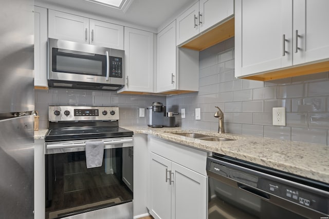203 Stearns Pt Unit F3, Hot Springs, AR 71913 - kitchen with appliances with stainless steel finishes, a sink, white cabinets, tasteful backsplash, and light stone counters