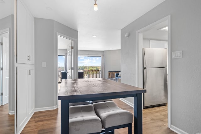 203 Stearns Pt Unit F3, Hot Springs, AR 71913 - kitchen featuring freestanding refrigerator, white cabinets, wood finished floors, baseboards, and a textured wall