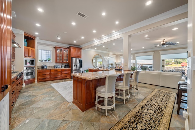347 Paradise Pt, Hot Springs, AR 71913 - kitchen with appliances with stainless steel finishes, ornamental molding, open floor plan, brown cabinetry, and healthy amount of natural light