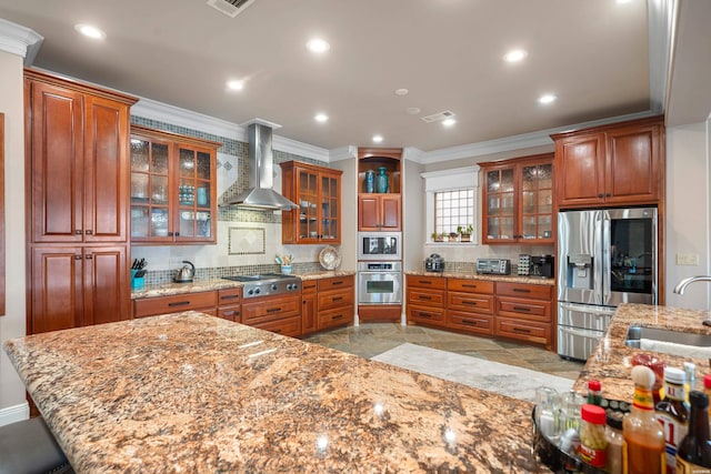 347 Paradise Pt, Hot Springs, AR 71913 - kitchen with stainless steel appliances, wall chimney exhaust hood, ornamental molding, tasteful backsplash, and brown cabinetry