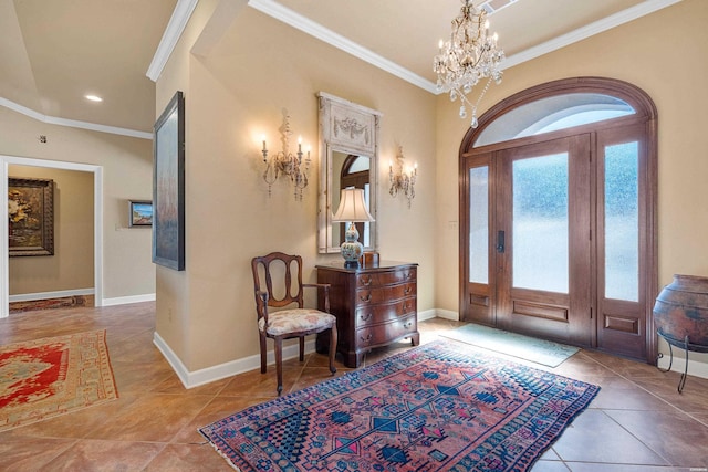 tiled foyer entrance with baseboards, an inviting chandelier, and ornamental molding