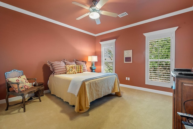 bedroom featuring visible vents, light carpet, crown molding, baseboards, and ceiling fan