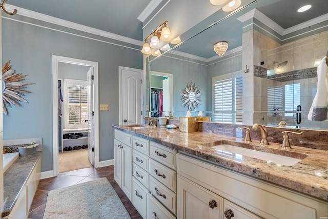 full bath featuring double vanity, ornamental molding, a stall shower, and a sink