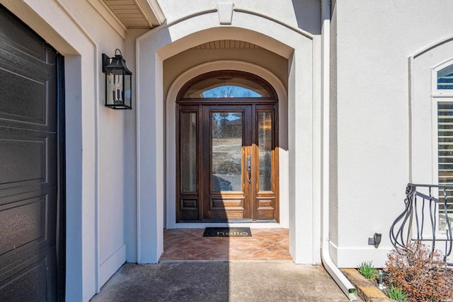 doorway to property with stucco siding