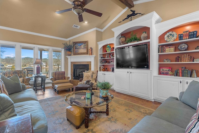 living area featuring tile patterned floors, visible vents, a ceiling fan, vaulted ceiling with beams, and a tile fireplace