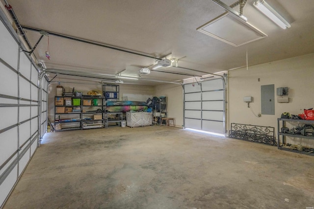 garage with electric panel and a garage door opener