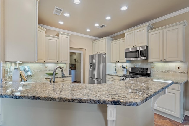 kitchen featuring light stone counters, visible vents, a peninsula, stainless steel appliances, and crown molding