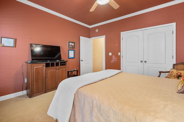 bedroom featuring light carpet, a closet, crown molding, baseboards, and ceiling fan