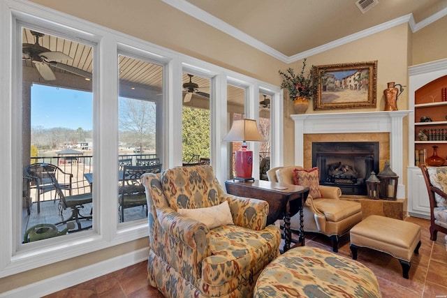 sitting room with plenty of natural light, crown molding, and ceiling fan