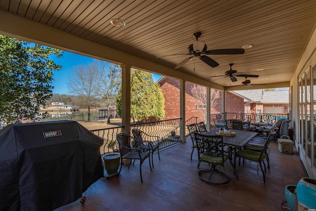 view of patio / terrace featuring outdoor dining space, a grill, and a ceiling fan