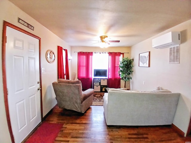 living room with dark wood-type flooring, baseboards, a ceiling fan, and a wall mounted AC