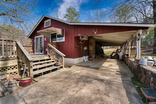 144A Isaac Ln, Hot Springs, AR 71901 - rustic home with concrete driveway, a wooden deck, and an attached carport