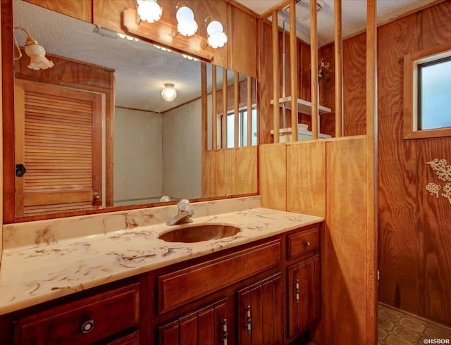 bathroom featuring a textured ceiling and vanity