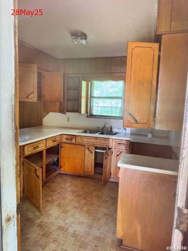 501 N Byrd St, Crossett, AR 71635 - kitchen featuring brick patterned flooring, a sink, and light countertops
