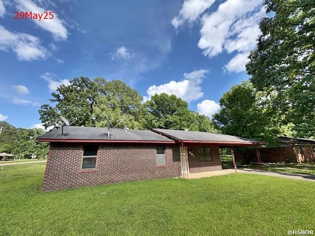 501 N Byrd St, Crossett, AR 71635 - rear view of property with a yard, driveway, a carport, and a patio