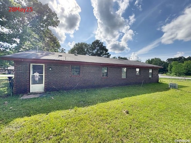 501 N Byrd St, Crossett, AR 71635 - rear view of property featuring brick siding, a yard, and central air condition unit