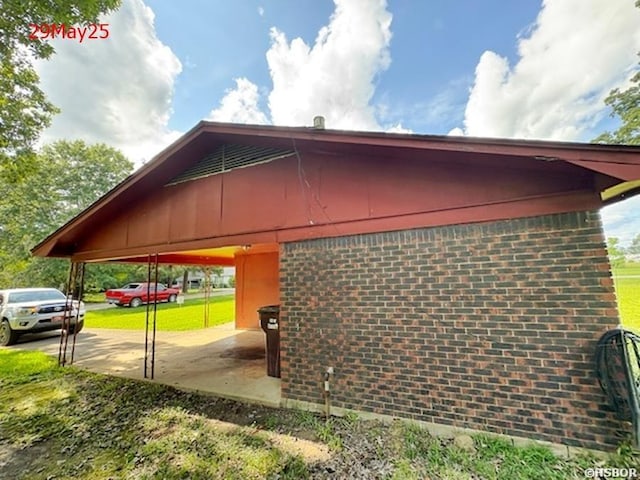 501 N Byrd St, Crossett, AR 71635 - view of home's exterior featuring brick siding and concrete driveway