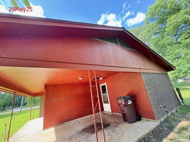 501 N Byrd St, Crossett, AR 71635 - view of home's exterior with brick siding, a lawn, and a patio