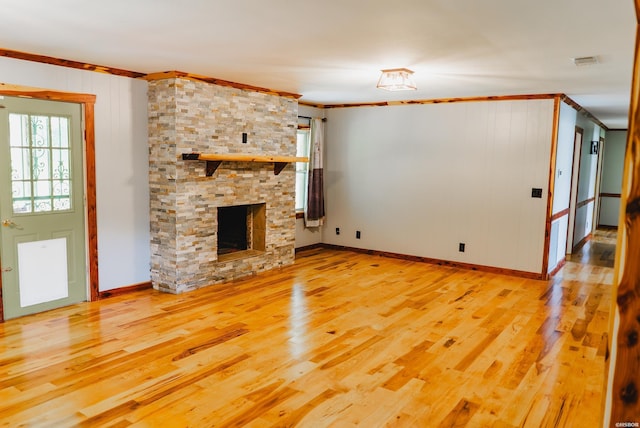 114 Roy Cir, Monticello, AR 71655 - unfurnished living room with wood finished floors, crown molding, a fireplace, and baseboards