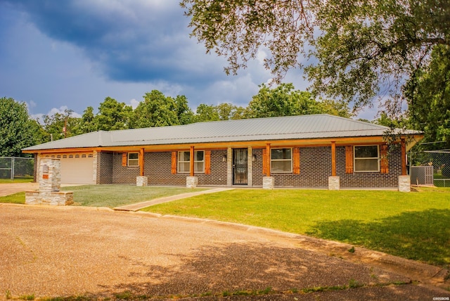114 Roy Cir, Monticello, AR 71655 - ranch-style house with brick siding, an attached garage, concrete driveway, and metal roof