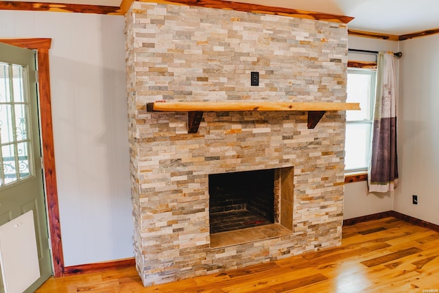 114 Roy Cir, Monticello, AR 71655 - detailed view of wood finished floors, ornamental molding, radiator heating unit, baseboards, and a fireplace