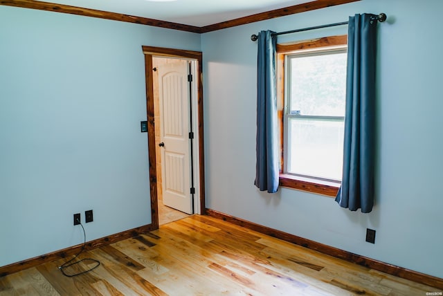 114 Roy Cir, Monticello, AR 71655 - unfurnished room with baseboards, plenty of natural light, and wood finished floors