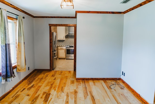 114 Roy Cir, Monticello, AR 71655 - empty room featuring ornamental molding, light wood-style floors, and baseboards