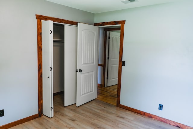 114 Roy Cir, Monticello, AR 71655 - unfurnished bedroom featuring light wood-style floors, baseboards, and a closet